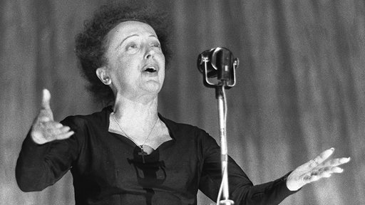 Picture dated 30 December 1960 of French singer Edith Piaf performing on stage at the Olympia during a show in Paris